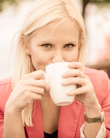 Young Woman Holding Cup of Coffeeの写真素材