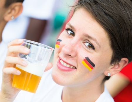 German Supporter Drinking Beer at Stadiumの写真素材
