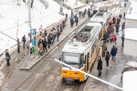 BUDAPEST, HUNGARY - MARCH 28: People at tram station and snow all around on March 28, 2013 in Budapest, Hungary.のeditorial素材