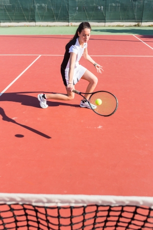 Young Woman Playing Tennisの写真素材