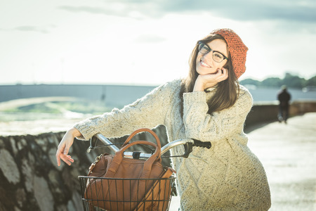 Old Fashioned Woman with Bicycle in the Cityの写真素材