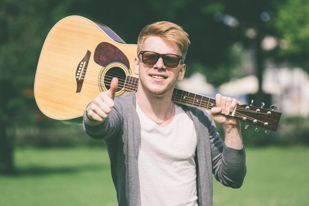 Young Russian Man Holding Guitarの写真素材