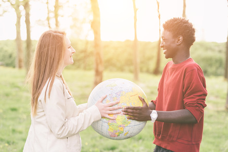 Multiracial Teen Couple Holding Globe Mapの写真素材