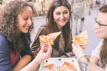 Girls Eating Pizza in the Cityの写真素材