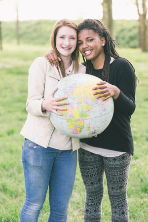 Multiracial Girls Holding Globe Mapの写真素材