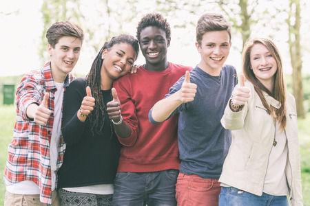 Multiethnic Group of Teenagers with Thumbs Upの写真素材