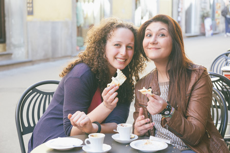 Girls Having Italian Traditional Breakfast at Barの写真素材