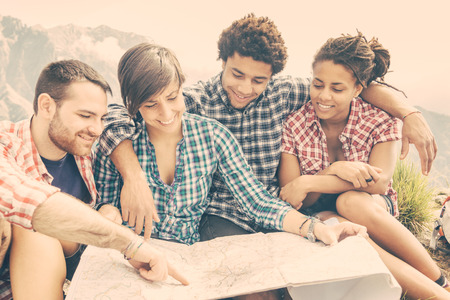 Hikers Looking at Map on top of Mountain