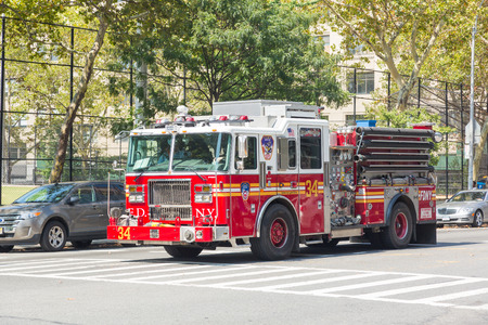 NEW YORK, USA - AUGUST 20, 2014: FDNY fire truck on Manhattan 9th Avenue. FDNY provide both Fire and EMS services.のeditorial素材