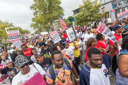 NEW YORK, USA - AUGUST 23, 2014: Thousands march in Staten Island to protest Eric Garner’s death by NYPD cops. NEW YORK, USA - AUGUST 23, 2014: Thousands march in Staten Island to protest Eric Garner’s death by NYPD cops.