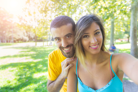 Young Couple Taking Selfie at Parkの写真素材