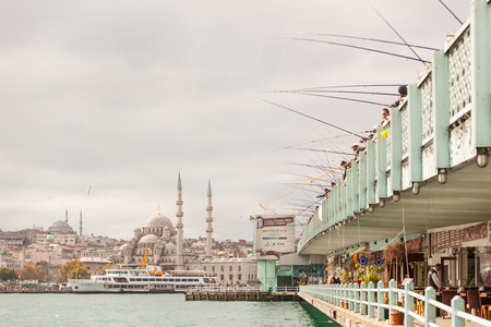 ISTANBUL, TURKEY - OCTOBER 26, 2014: View of Yeni Camii (the New Mosque) and Galata brigde woth lot of fishermen fishing.のeditorial素材