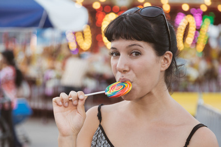Happy Young Woman eating Lollipopの写真素材