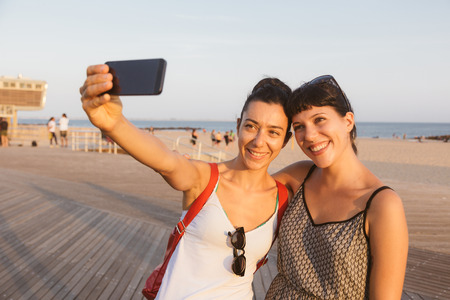 Beautiful Young Women Taking Selfie in Coney Islandの写真素材