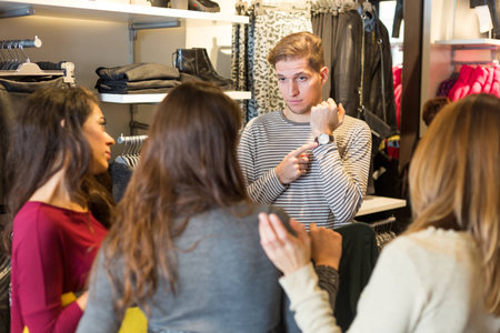 Bored Man Waiting for Women in a Clothing Storeの写真素材