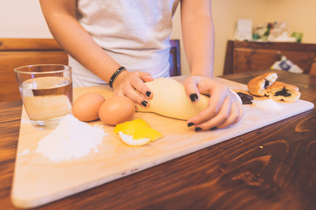 Young Woman Kneading Water and Flourの写真素材