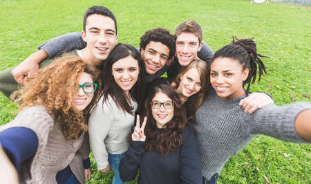 Multiethnic Group of Friends Taking Selfie at Parkの写真素材