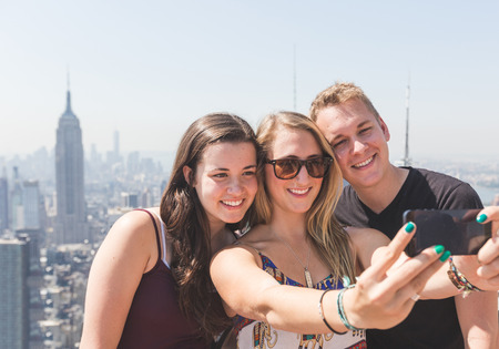 Friends Taking Selfie with New York on Backgroundの写真素材