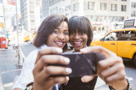 Two Beautiful Black Woman taking Selfie in New Yorkの写真素材