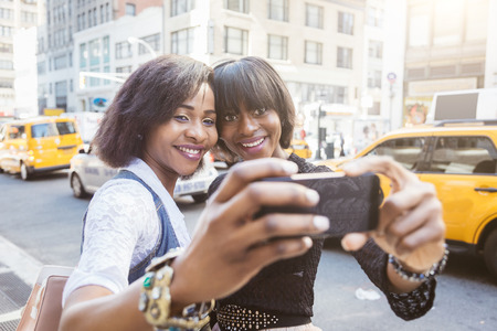 Two Beautiful Black Woman taking Selfie in New Yorkの写真素材