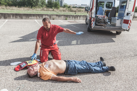 Doctor Providing First Aid with a Defibrillatorの写真素材