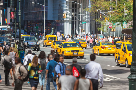 NEW YORK, USA - AUGUST 28, 2014: Crowded 5th Avenue with tourists on sidewalk and yellow cabs on the street.のeditorial素材