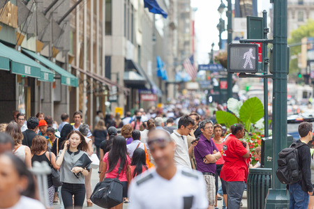 NEW YORK, USA - AUGUST 28, 2014: Crowded sidewalk on 5th Avenue with tourists and commuters on a...
