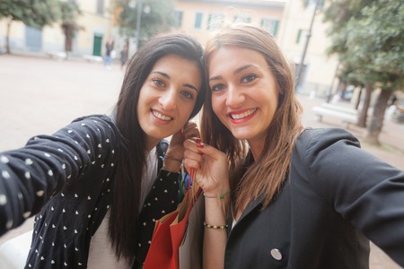 Happy Women Taking Selfie after Shoppingの写真素材