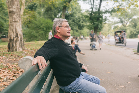 Retired Senior Man at Park, Seated on a Bench