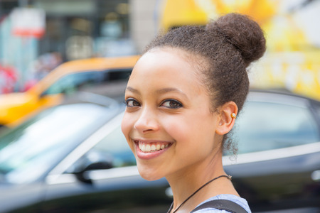 Beautiful Mixed-Race Young Woman in the City, Smiling Portraitの写真素材