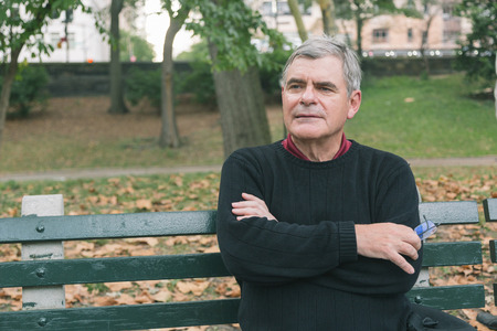 Retired Senior Man at Park, Seated on a Benchの写真素材