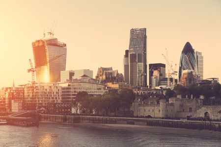 Tower of London and Modern Skyscrapers on Background at Sunsetの写真素材
