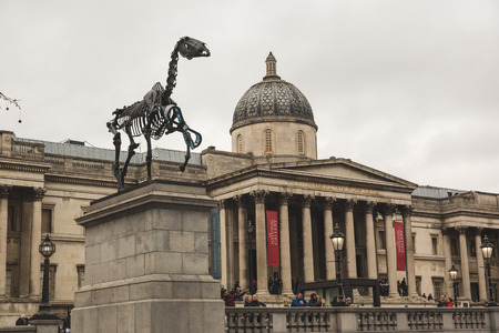 LONDON, UNITED KINGDOM - MARCH 8, 2015: Gift Horse, the new sculpture on the Fourth Plinth in Trafalgar Square, with National Gallery on backgroundのeditorial素材