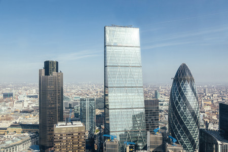 Modern skyscrapers in London city, aerial view from another skyscraper. Sun reflection on skyscraper facade.のeditorial素材