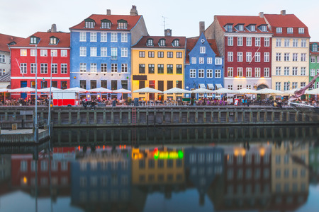 Colorful houses in Copenhagen old town, with boats and ships in the canal in front of them. Long exposure shot in late afternoon.のeditorial素材