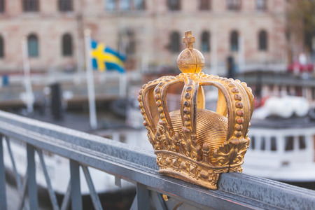 Golden crown with swedish flag on background in Stockholm.の写真素材