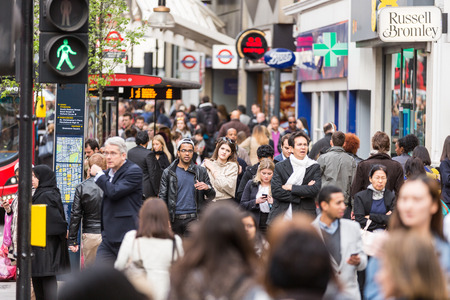 LONDON, UNITED KINGDOM - APRIL 17, 2015: Crowded sidewalk on Oxford Street with commuters and tourists from all over the world.のeditorial素材