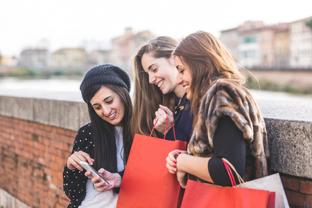 Happy Women with Smart Phone and Shopping Bagsの写真素材
