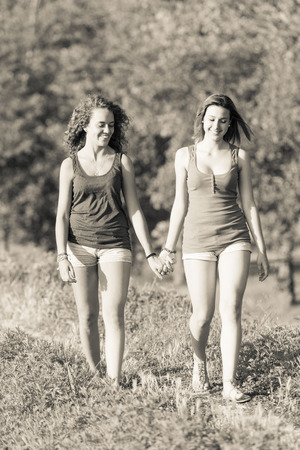Two Beautiful Teenage Girls Walking at Parkの写真素材