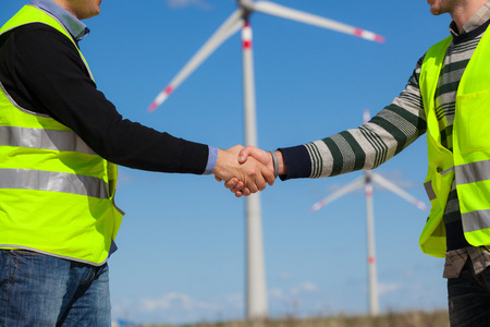 Engineers giving Handshake in a Wind Turbine Power Stationの写真素材