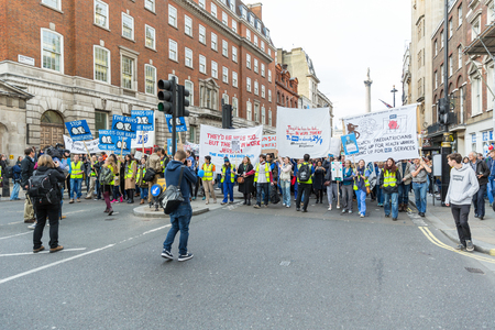 LONDON, UK - OCTOBER 17, 2015: Thousands Junior doctors marching in London streets to campaign against NHS contract changesのeditorial素材