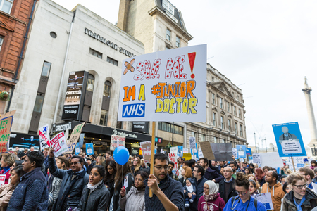 LONDON, UK - OCTOBER 17, 2015: Thousands Junior doctors marching in London streets to campaign against NHS contract changesのeditorial素材