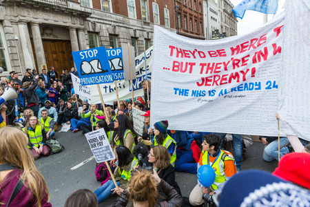 LONDON, UK - OCTOBER 17, 2015: Thousands Junior doctors marching in London streets to campaign against NHS contract changesのeditorial素材