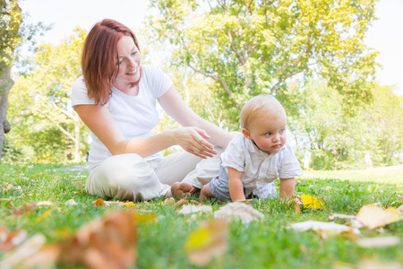 Happy mother and baby son at park in New York. The woman is on her mid thirties and the child is...