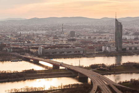 Panoramic view of Wien at sunset, with Danube river, highway and buildings on background. This is an aerial photo of the capital city of Austria, with concepts of travel and European architecture.の写真素材