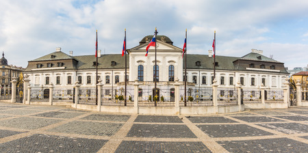 BRATISLAVA, SLOVAKIA - MARCH 23: Presidential palace with Slovakian flags in front of the entrance. There is nobody in the square and on the front yardのeditorial素材