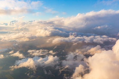 Cloudscape aerial view from airplane window seat. Photo taken at sunset, with a beautiful light. Background ready picture.の写真素材