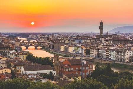 Panoramic view of Florence at sunset. On the left there is Ponte Vecchio and on the right Palazzo Vecchio. Photo taken at sunset from Michelangelo panoramic terrace.の写真素材
