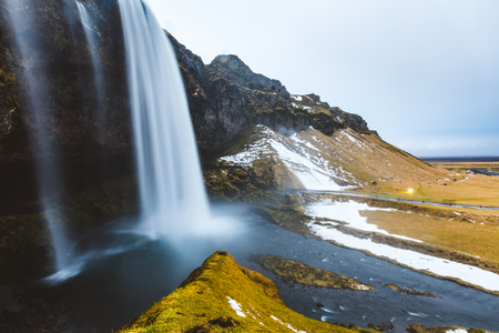Seljalandsfoss waterfall in Iceland, long exposure. Side view of the majestic Seljalandsfoss, famous waterfall in the south of Iceland. Travel and nature conceptsの写真素材