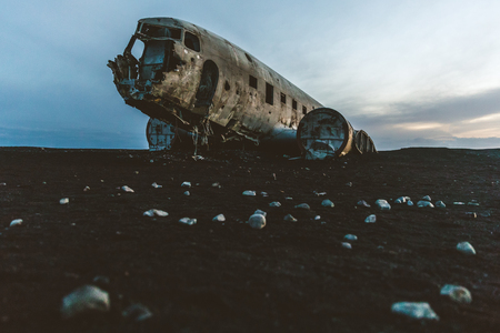 Iceland, Airplane wreck at Solheimasandur. Old and abandoned airplane, crashed on the black beach, at dusk, with nobody around. Travel and transport concepts.の写真素材